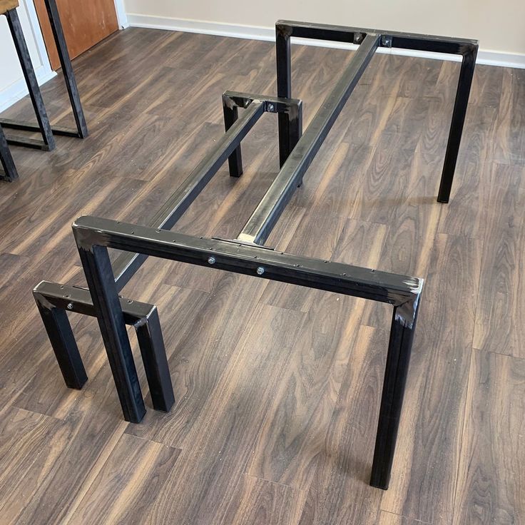 three metal tables sitting on top of a hard wood floor