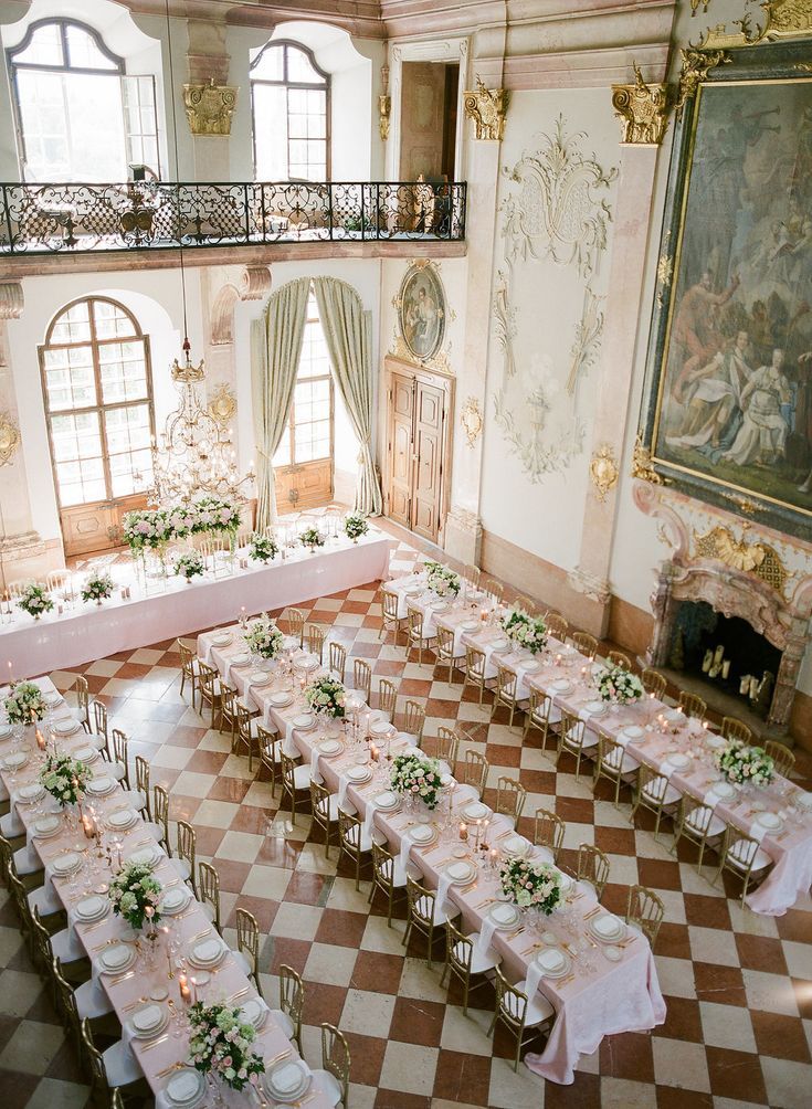 a large room with tables and chairs set up for a formal function in the center