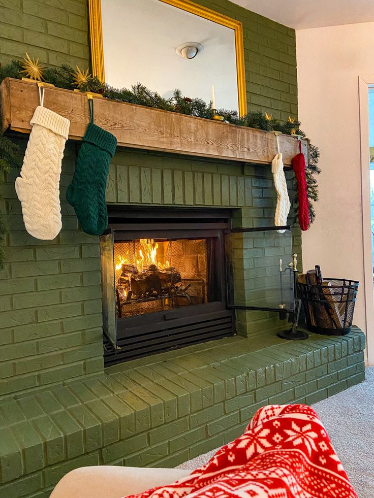 a fireplace with stockings hanging from the mantle