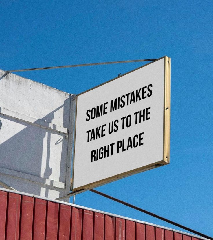 a sign on the side of a building that says some mistakes take us to the right place