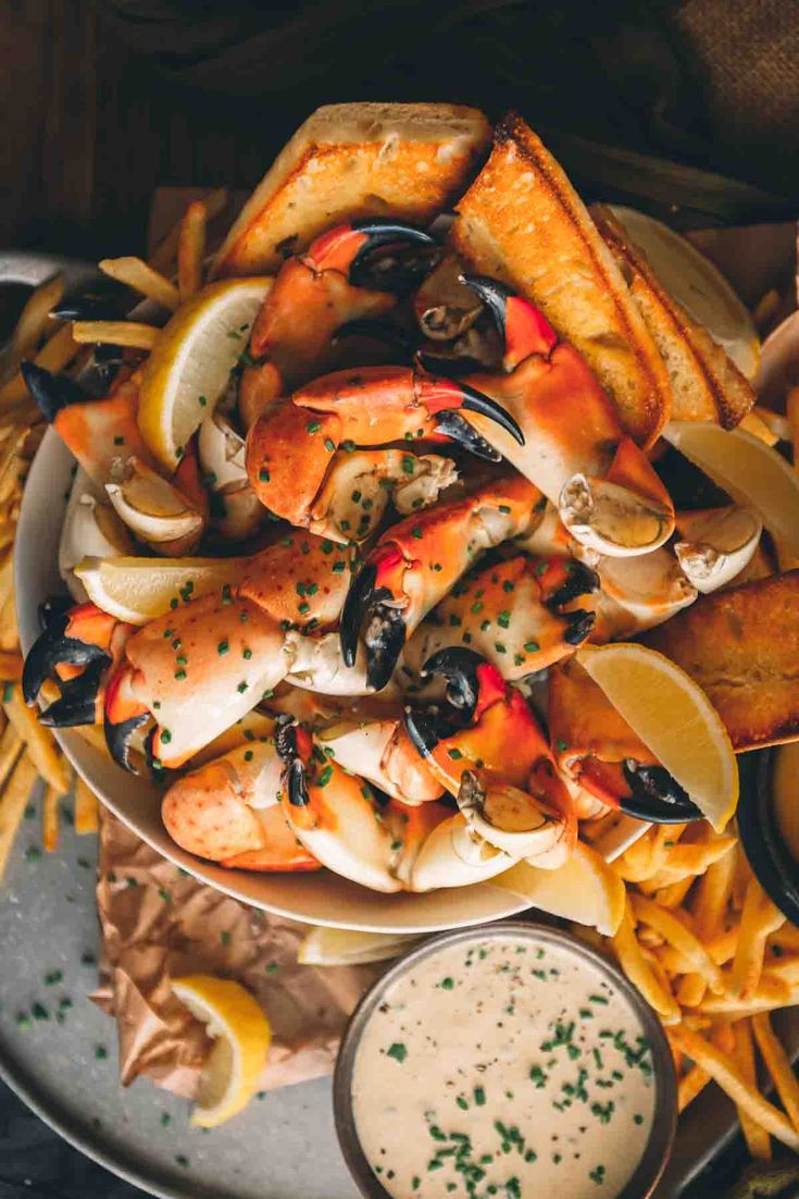 a platter filled with seafood and fries