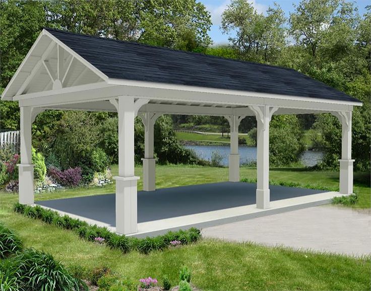 a white gazebo sitting on top of a lush green field