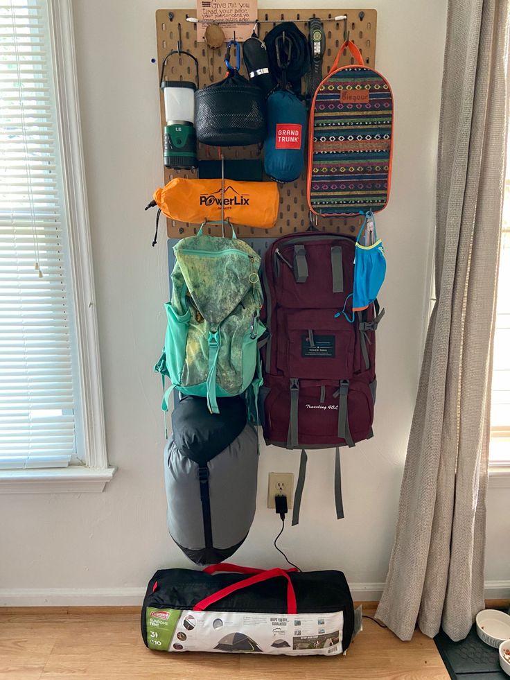 Camping and hiking  gear storage using pegboards. Camp Gear Storage Ideas, Pegboard Camping Gear Storage, Camping Gear Pegboard, Backpacking Storage Ideas, Outdoor Gear Storage Apartment, Hiking Gear Organization Ideas, Hiking Room Decor, Pegboard Gear Wall, Hiking Gear Peg Board