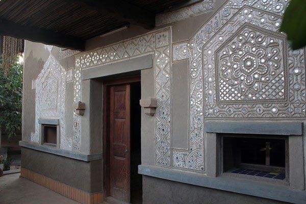 an ornately decorated building with a wood door