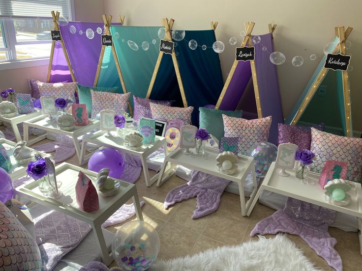 a room filled with lots of purple and green decorations