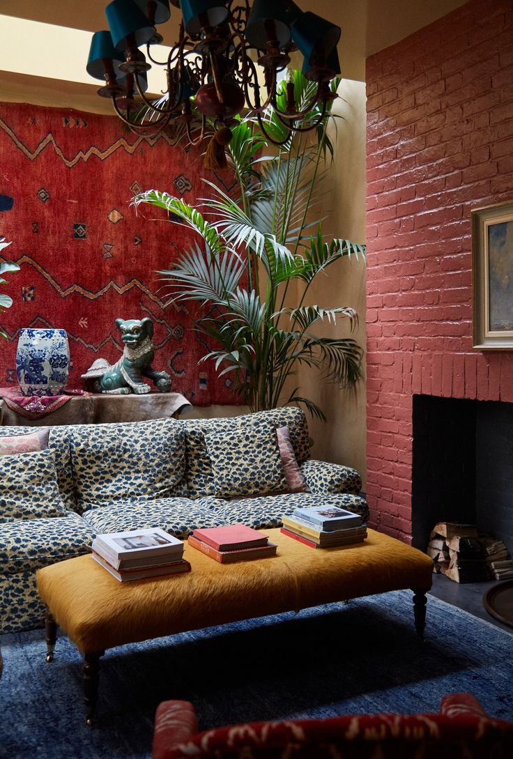 a living room with a couch, coffee table and potted plant in the corner