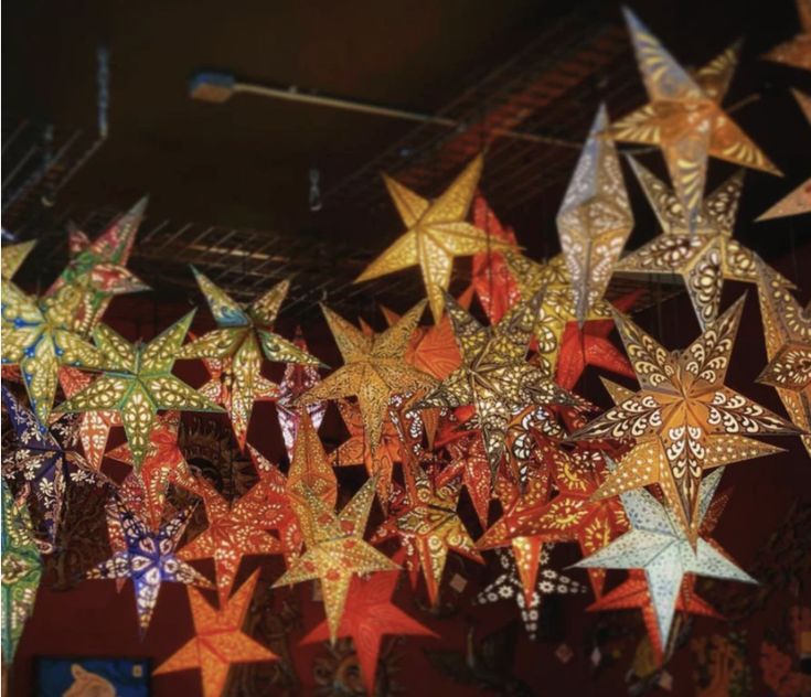 colorful paper stars are hanging from the ceiling