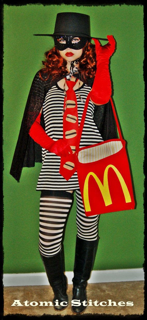 a woman dressed up as a mcdonald's hero with a hat, cape and bag