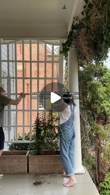 two people are standing on the porch with their hands out and one person is pointing