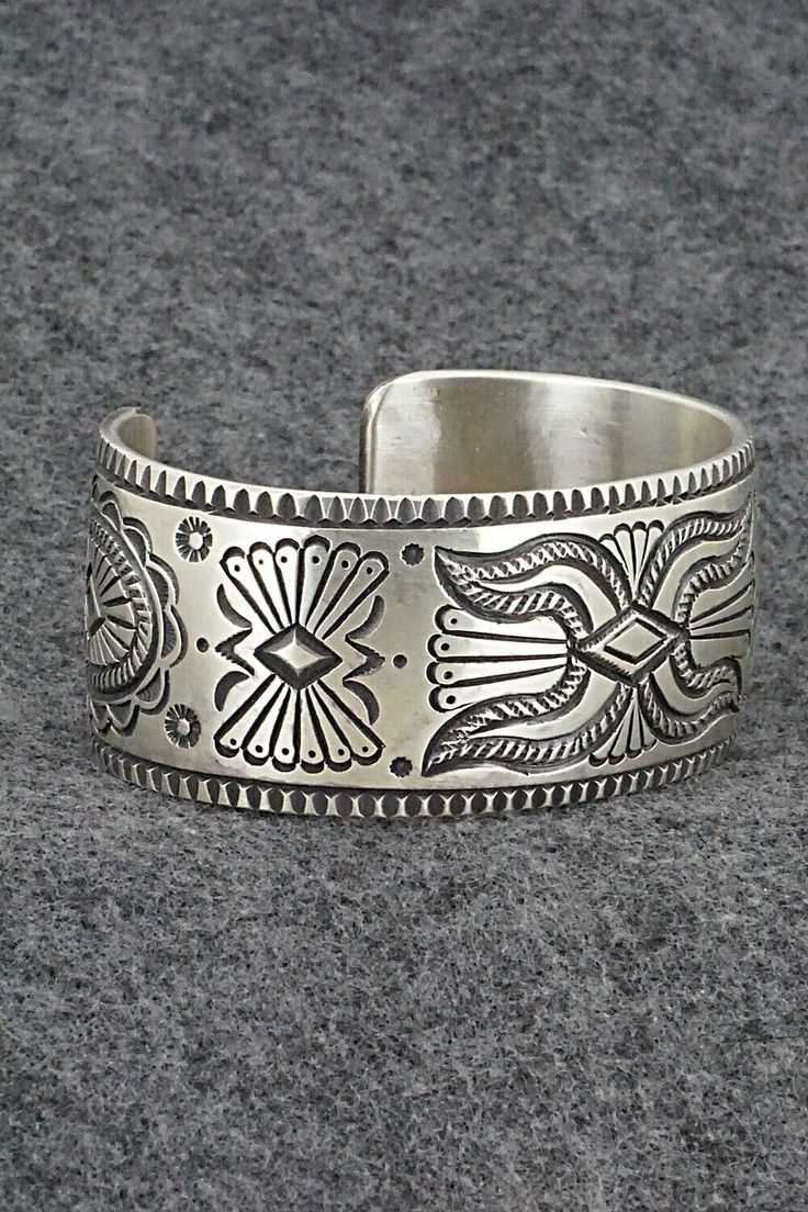 This exceptionally crafted sterling silver bracelet was made by Navajo silversmith Calvin Martinez. The inside is signed C MTZ, Navajo and stamped sterling.Size: 5 3/8" (will fit up to a 6 3/8" wrist)Gap: 1"Width: 1 1/16"Free shipping on all orders! We ship with USPS and always include tracking. All orders ship within a day of payment.Returns are accepted up to 30 days after you receive your order. Just send us a message. Our shop offers cash back or store credit. The item must be returned in ne Southwestern Engraved Sterling Silver Bracelet Gift, Engraved Sterling Silver Bracelet Gift, Bohemian Etched Sterling Silver Bracelets, Engraved Sterling Silver Bohemian Bracelet, Bohemian Sterling Silver Engraved Bracelet, Bohemian Cuff Bracelet With Polished Finish, Stamped Sterling Silver Bohemian Cuff Bracelet, Southwestern Etched Bangle Jewelry, Bohemian Sterling Silver Stamped Cuff Bracelet