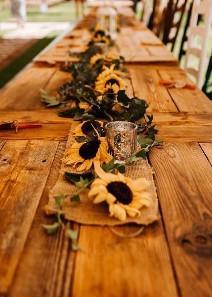 a long table with sunflowers on it