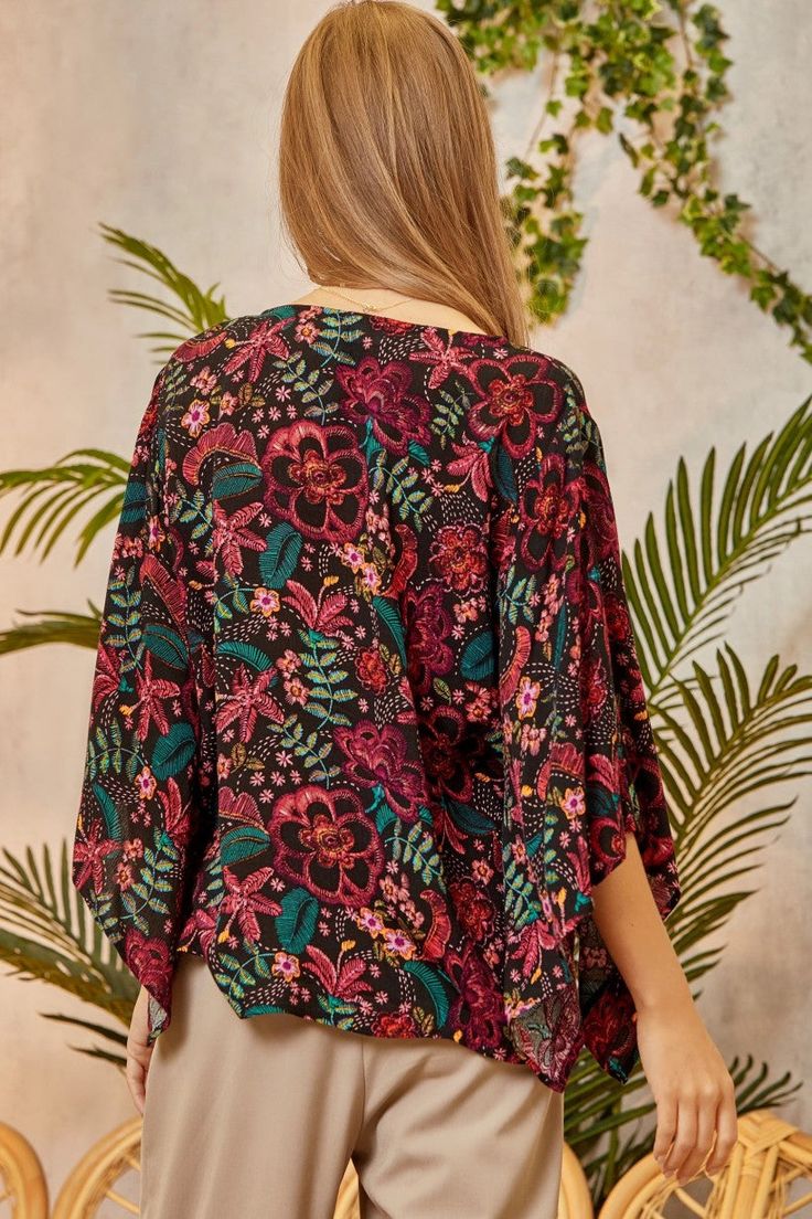 Fancy a bohemian update to your classic button down? This flowy floral print blouse features a flattering v-neckline and 3/4 length sleeves that make for a breezy yet polished style. The black background helps the printed flowers pop as you go about your day in a blouse that helps you find your cool, comfortable style. 100% Rayon Want to view this on the *Live* Sizing & Styling Guide?! Watch it in the photo section above or click here! *You will need to scan through to find this specific item on Multicolor Floral Print Rayon Blouse, Vacation Rayon Blouse With Floral Print, Floral Print Rayon Blouse For Vacation, Bohemian Blouse With 3/4 Sleeve Floral Print, Bohemian Floral Print Top With 3/4 Sleeves, Patterned Floral Print V-neck Blouse, Floral Print Beach Blouse With 3/4 Sleeves, Vacation Printed Blouse With 3/4 Sleeves, Beach Blouse With Floral Print And 3/4 Sleeves