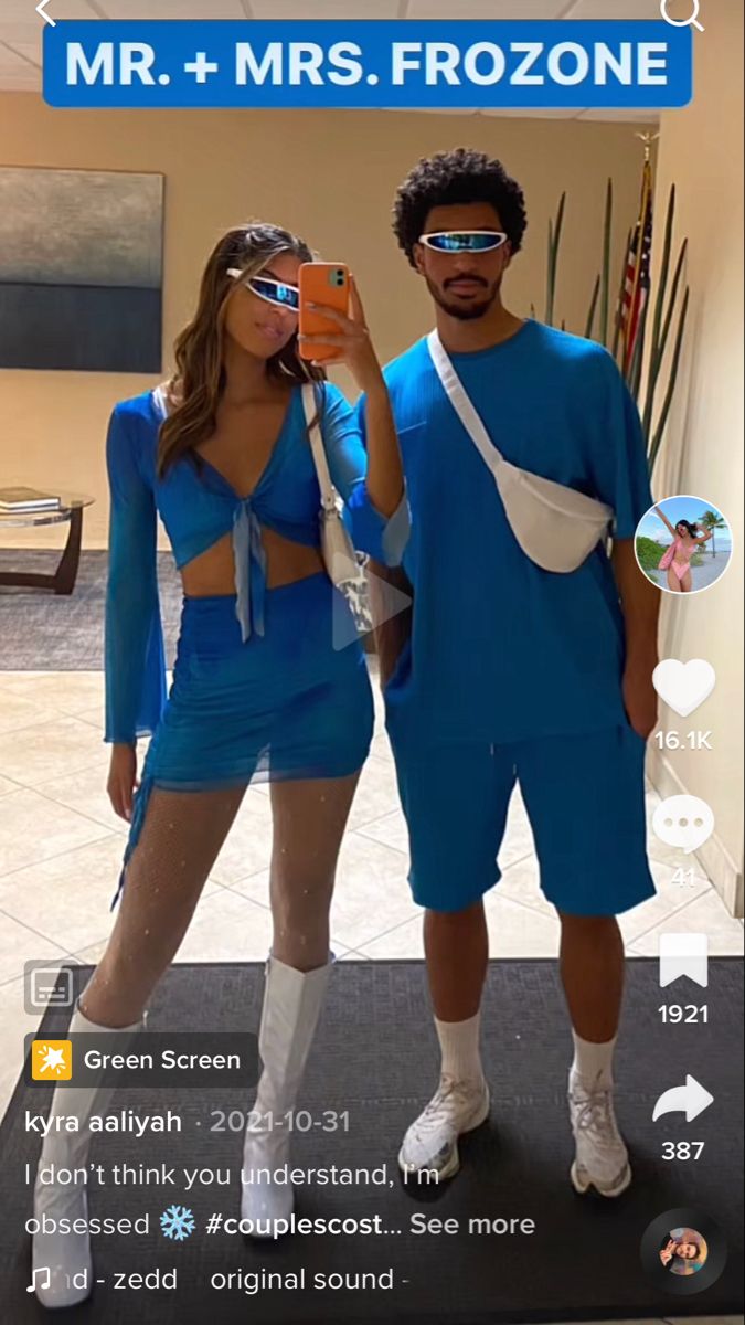 a man and woman in blue outfits taking a selfie on their cell phone with the caption mr + mrs frozone