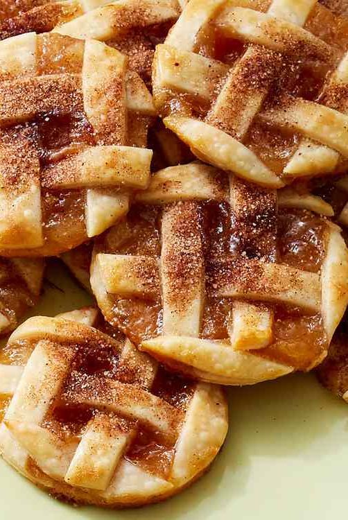 several pieces of pie on a plate with powdered sugar and syrup in the middle