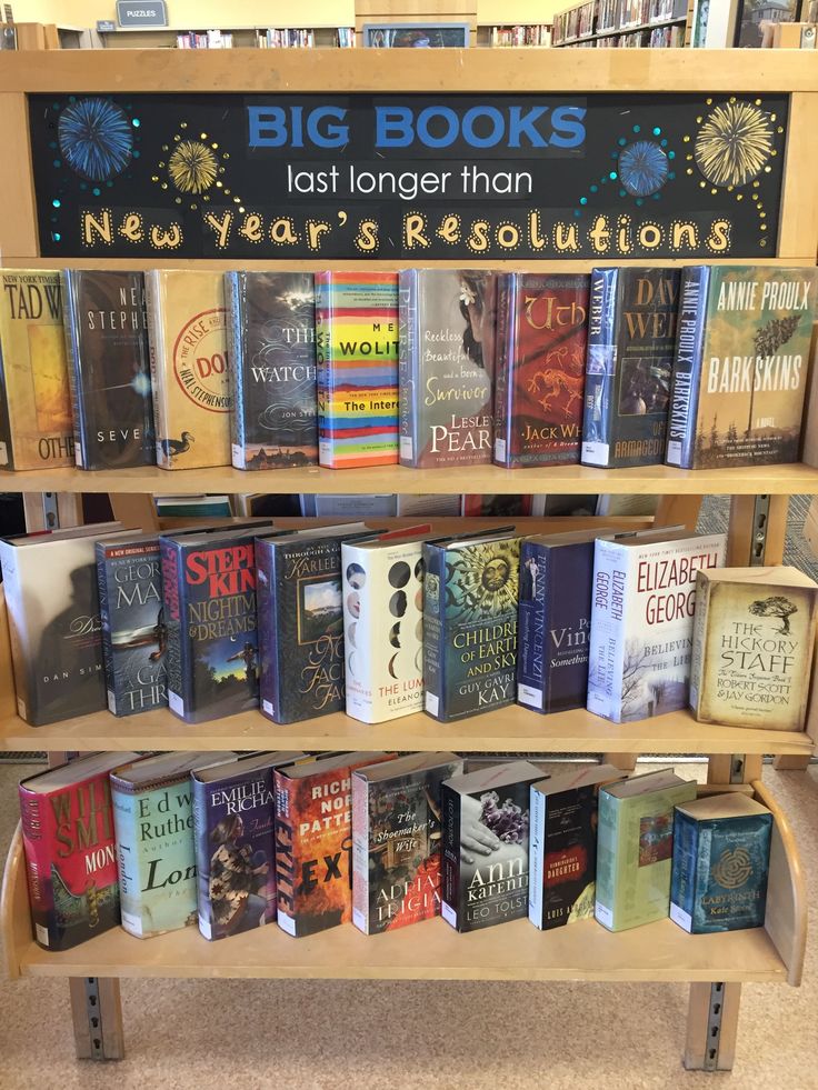 a book shelf filled with lots of books next to a sign that says big books last longer than new year's resolutions