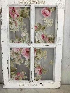 an old window with flowers painted on it