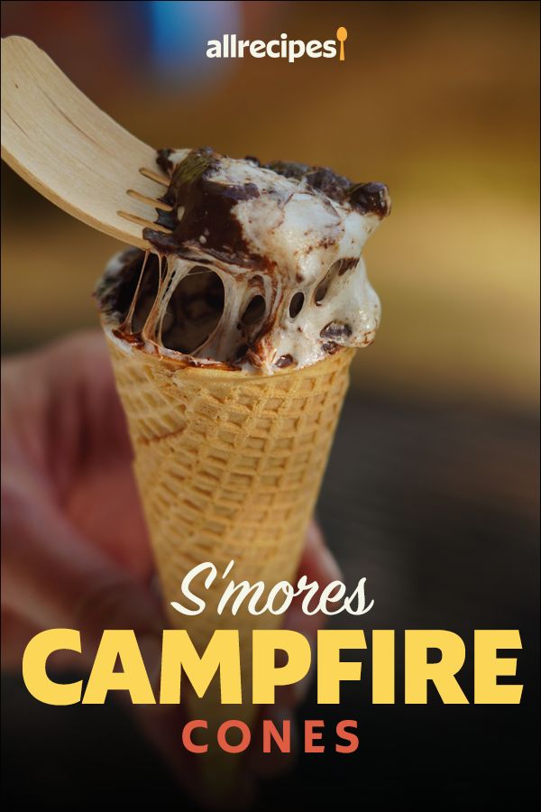 someone holding an ice cream cone with the words smores campfire cones