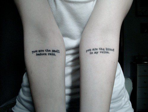 two people with tattoos on their arms that say, you are the blood before rain