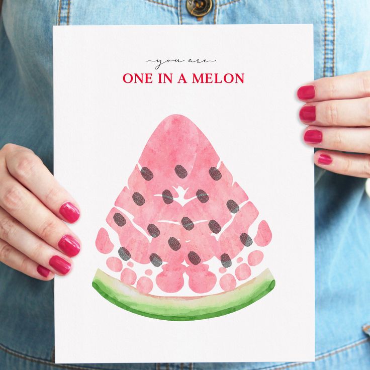 a woman holding up a card with a watermelon on it that says one in a melon