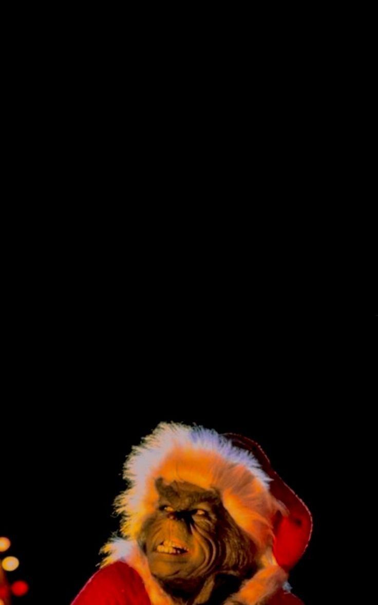 a man dressed as santa claus with lights in the background