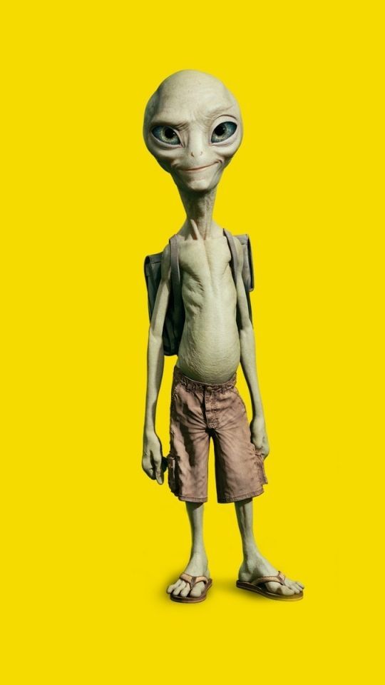 an alien standing in front of a yellow background