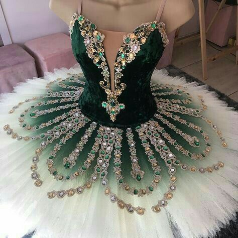 a green and white ball gown on display