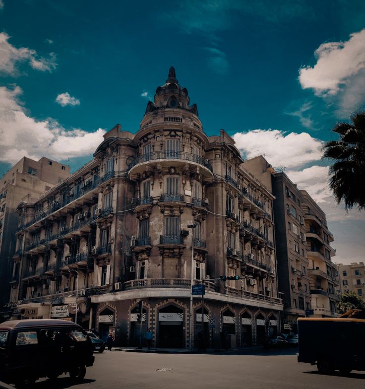 an old building with cars parked on the street