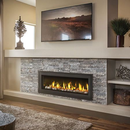 a living room with a fire place in the center and a painting on the wall