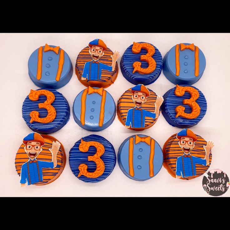 twelve blue and orange cupcakes with numbers on them