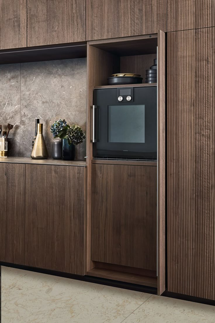 a kitchen with wooden cabinets and black appliances