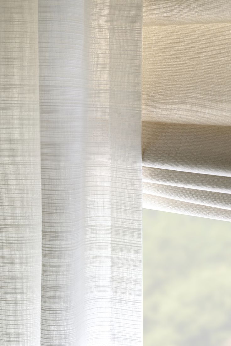 a close up view of a white curtain