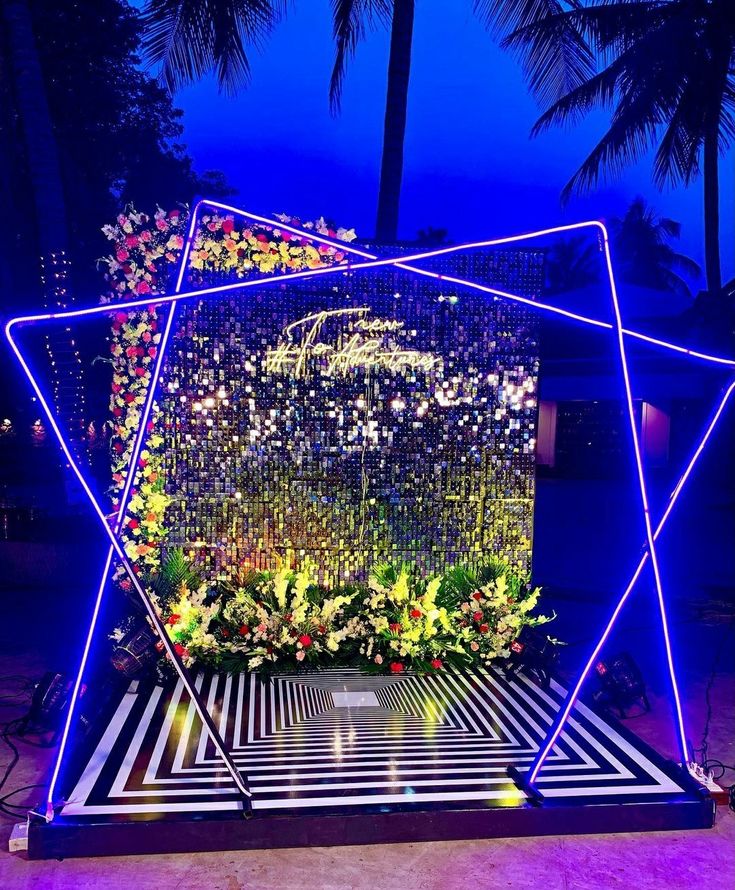 an artistic display with flowers and lights in the shape of a hexagonal structure