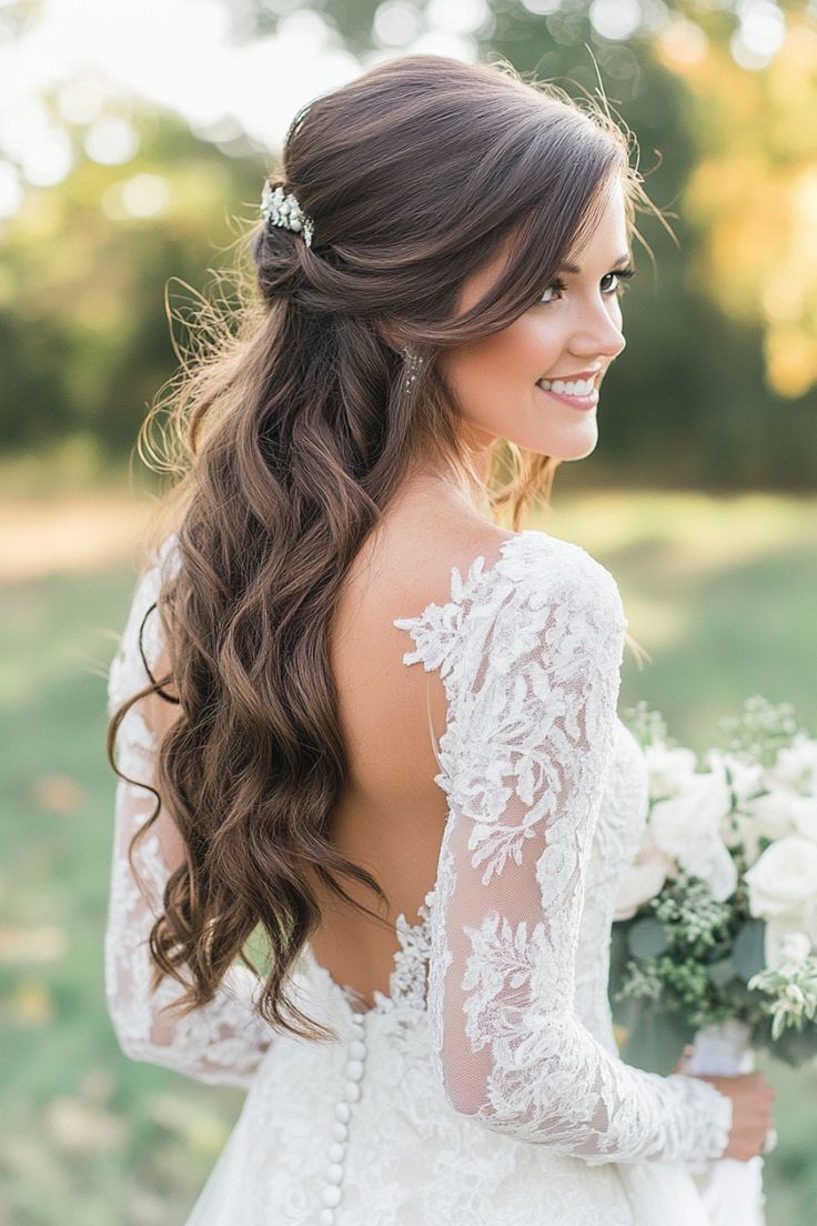 a woman in a wedding dress holding a bouquet and looking off into the distance with her back to the camera