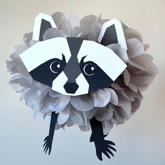 a paper plate with a raccoon on it's face hanging from the ceiling