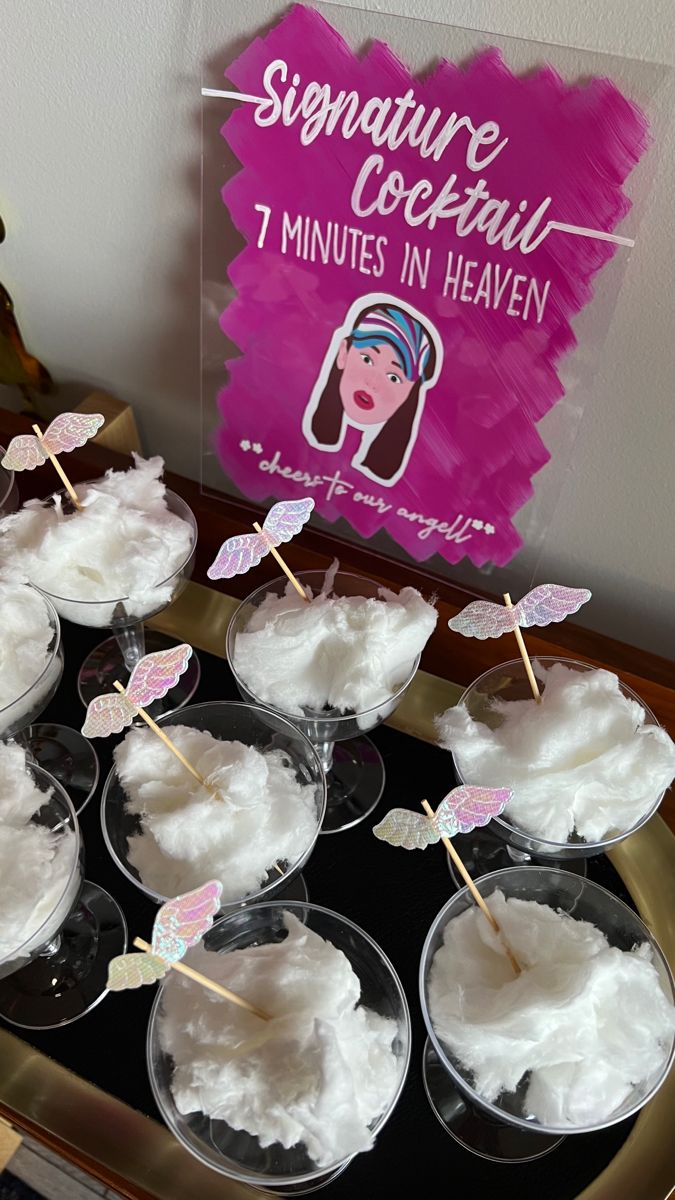 cupcakes with marshmallow toppings on a tray in front of a sign that reads signature cocktail 1 minutes in heaven