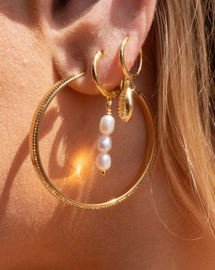 These sweet seashell hoops are a nostalgic reminder of warm sands and salty air on summer vacation. Subtle enough to wear everyday, these hoops are a gorgeous addition to your ear party. 14k Gold Vermeil Hypoallergenic Dimension: 11 mm hoop and shell Sold as a pair Yellow Gold-plated Hoop Earrings With Pearl Charm, Gold Round Earrings For Vacation, Elegant Round Hoop Earrings For The Beach, Gold Hoop Jewelry For Beach, Yellow Gold Pierced Earrings For Beach, Yellow Gold Beach Earrings, Gold Small Hoop Earrings For The Beach, Elegant Small Hoop Jewelry For The Beach, Gold Hoop Jewelry For Vacation