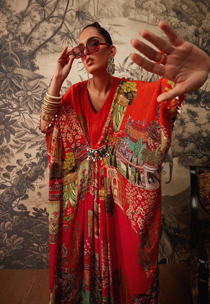 Editor's Note Featuring a vibrant printed kaftan with a v-neckline. It has an intricately handcrafted beadwork patch on the waistline. Fabric: Crepe Color: Orange Components: Kaftan Occasion: Daywear and resort Care: Dry Clean Only About the Designer Kalista is a luxury fashion label that specializes in designer clothing for millennial women. Founded by fashion designer turned entrepreneur, Pratyush Guglani, this indigenously curated label puts its own spin on ethnic and fusion couture. Their lu Orange Kaftan, Kaftan For Women, Printed Kaftan, Patchwork Coat, Kimono Pattern, Exotic Fashion, Cotton Linen Dresses, Fashionista Clothes, Over 50 Womens Fashion