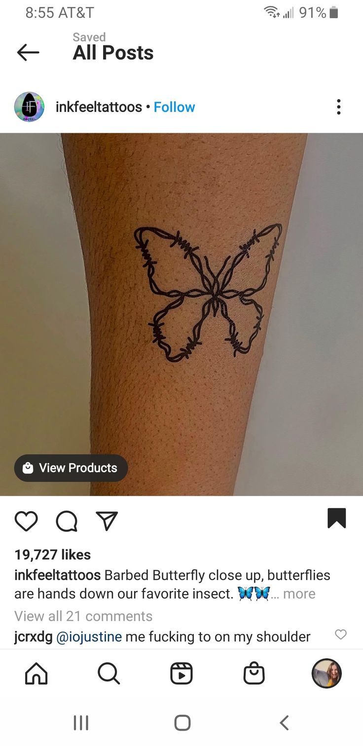 a tattoo on someone's leg that has a butterfly drawn on it