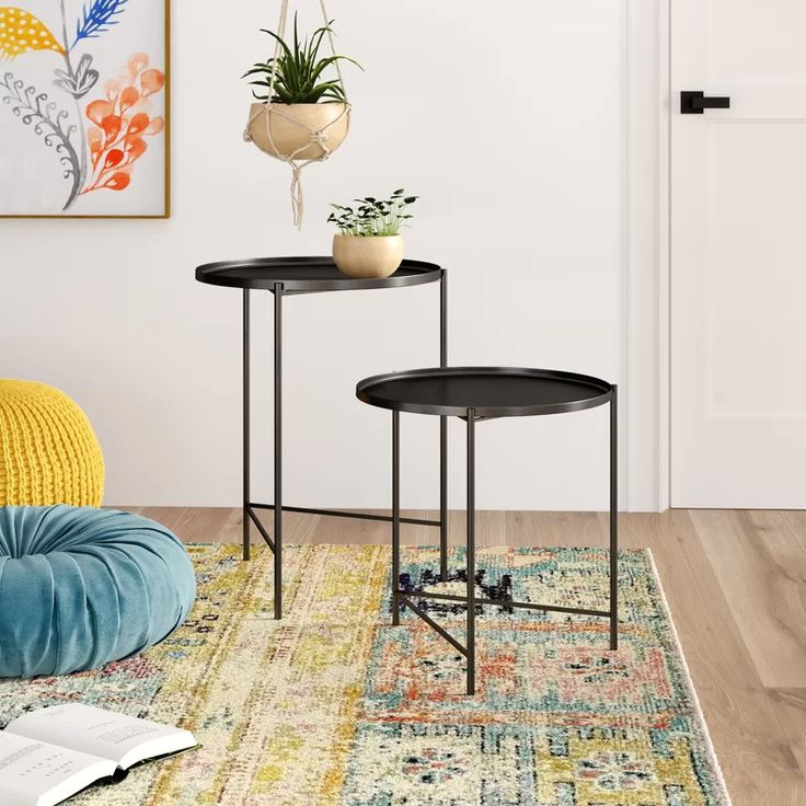 two tables with plants on them sitting in front of a white door and yellow chair