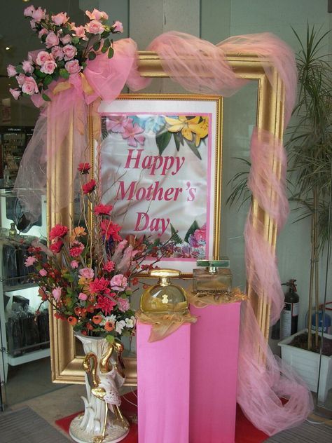 a pink and gold mother's day display with flowers