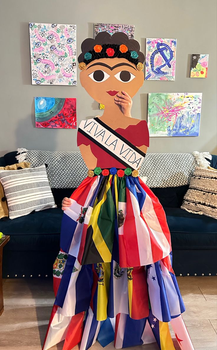 a cardboard cut out of a woman wearing a colorful dress and holding a name tag