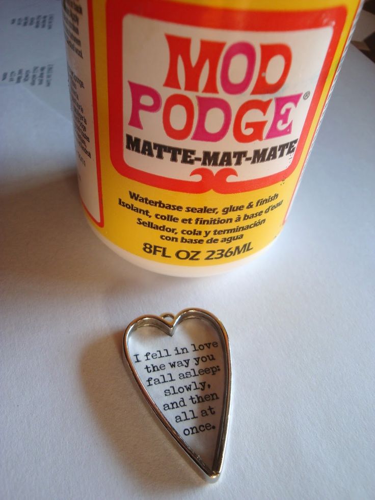 a metal heart shaped pin sitting on top of a table