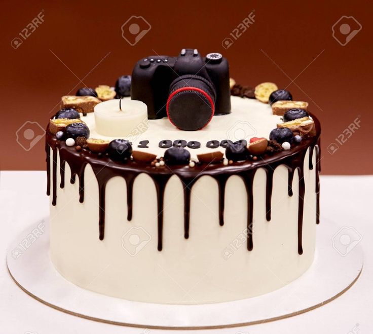 a cake decorated with chocolate icing and candies is on a plate, ready to be eaten