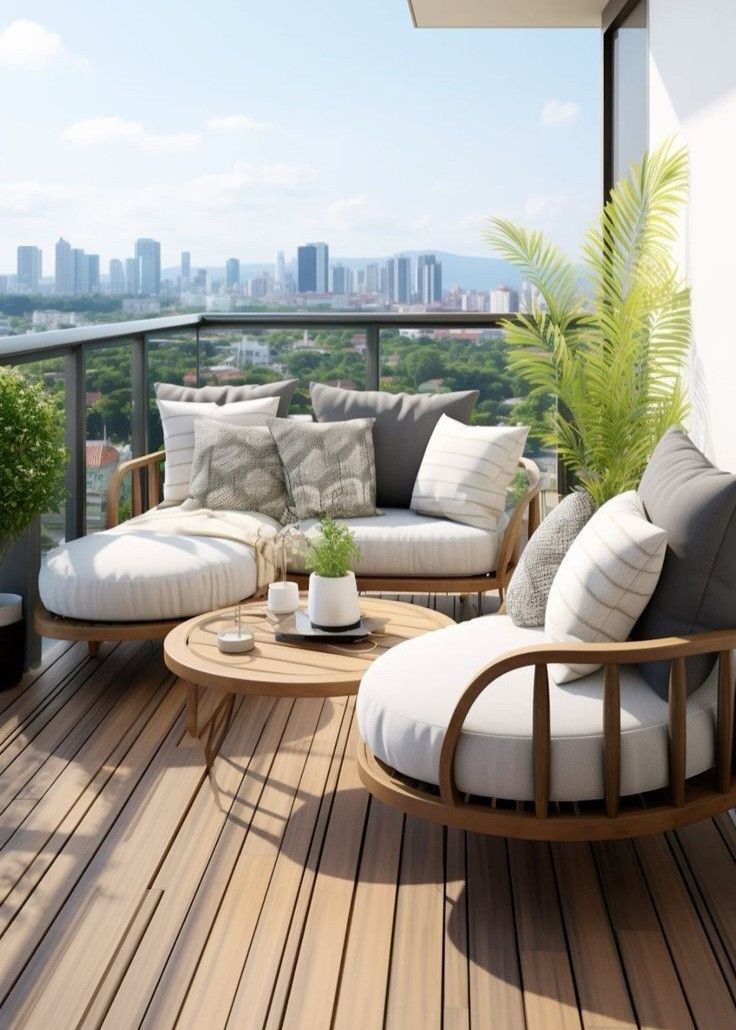 a wooden deck with two couches and chairs on it, overlooking the city skyline