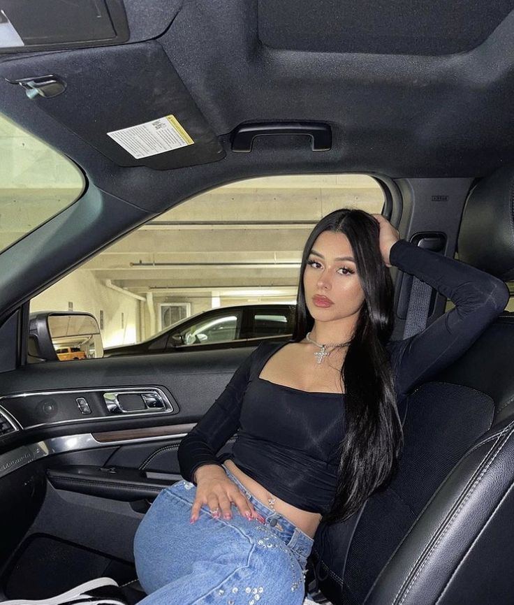 a woman sitting in the back seat of a car