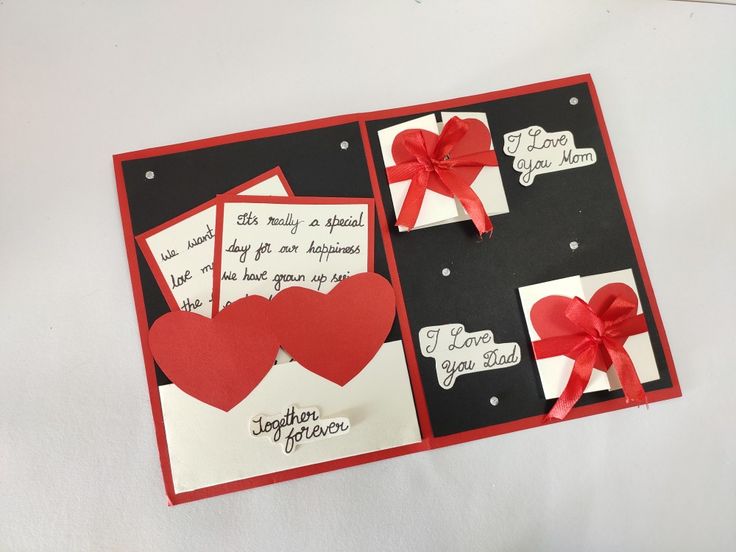 an open card with red hearts on it and some words written on the inside of each card