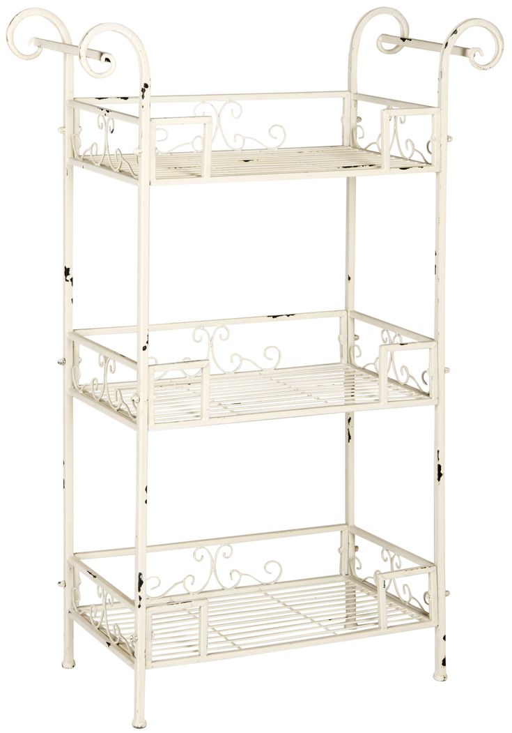 three tiered white metal shelf with scroll designs on the top and bottom, against a white background