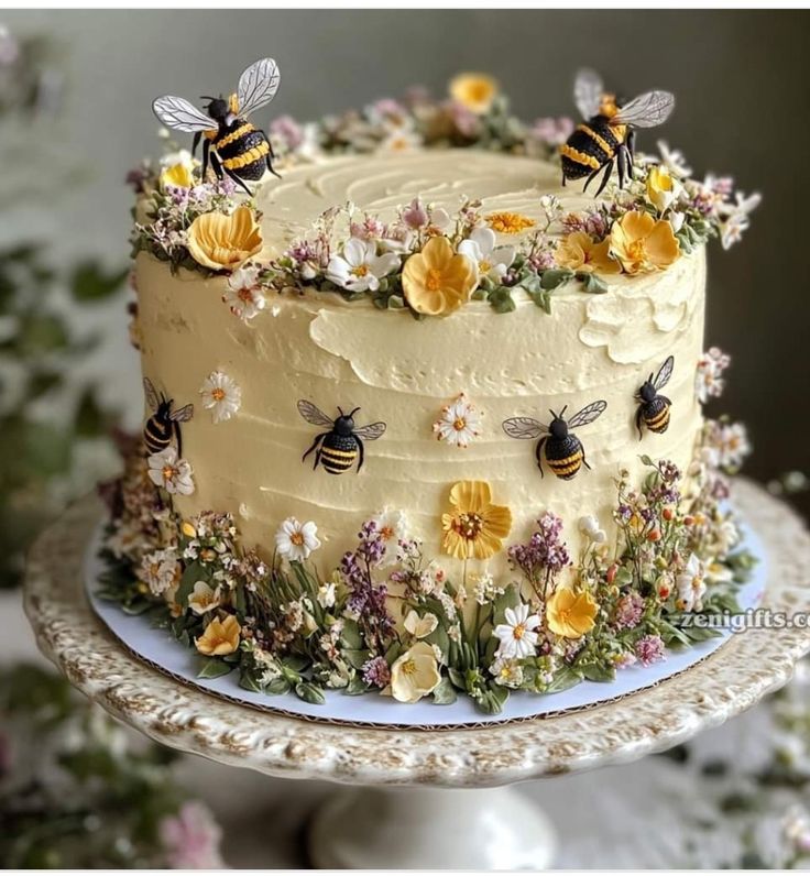 a cake with flowers and bees on it