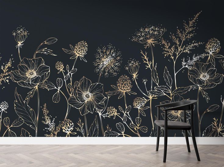 a black and gold floral wallpaper mural in an empty room