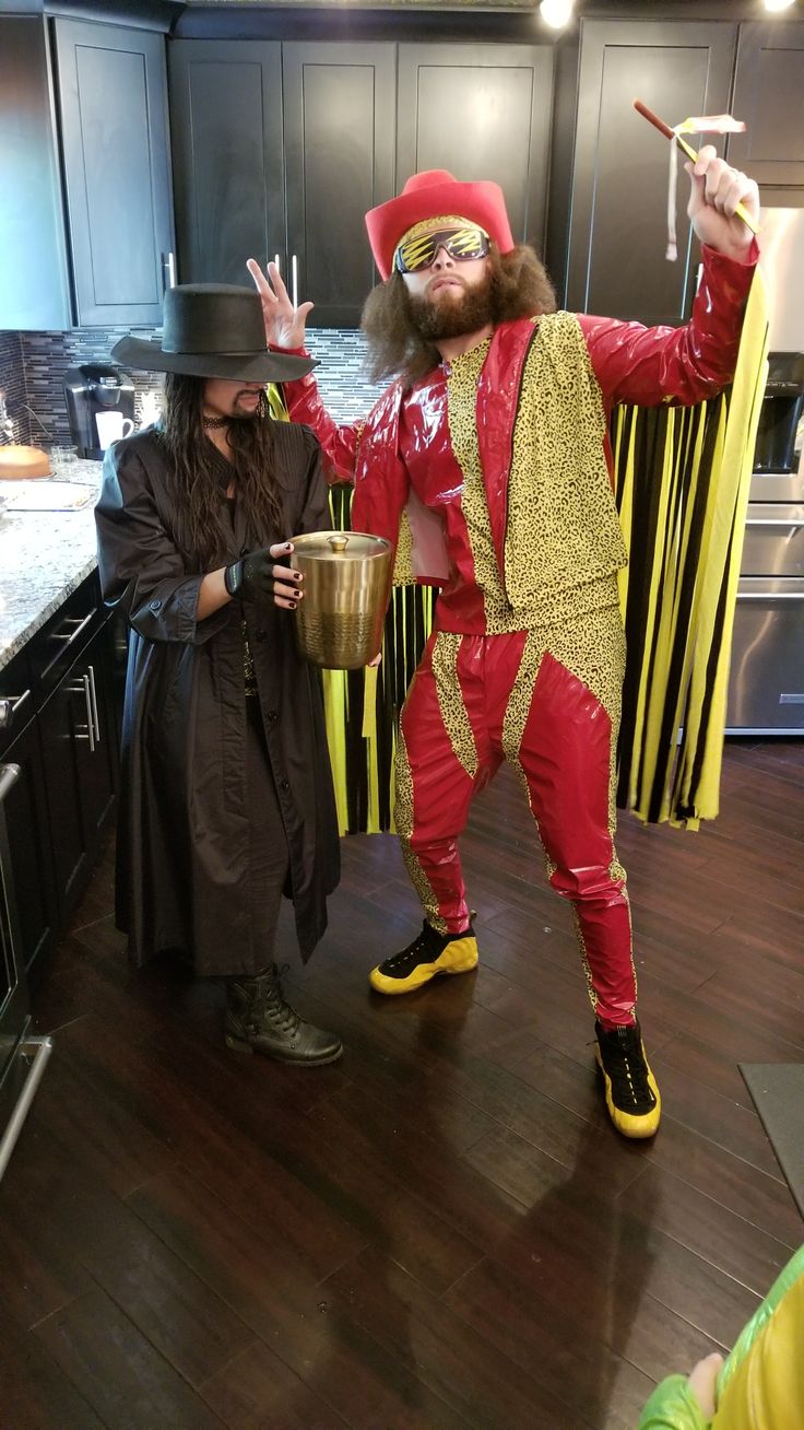 two people dressed up in costumes standing next to each other